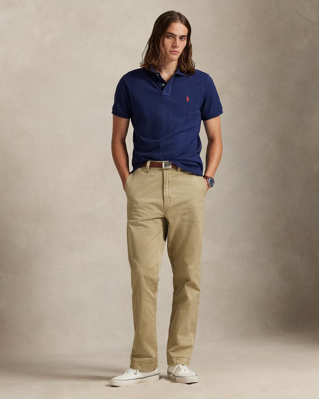 Classic fit polo shirt in navy blue worn with khaki pants, showcasing an American style standard by Ralph Lauren.